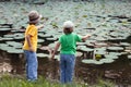 Happy boys go fishing on the river, Two children of the fisher w Royalty Free Stock Photo