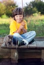 Happy boys go fishing on the river, Two children of the fisherman with a fishing rod on the shore of lake Royalty Free Stock Photo