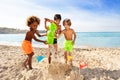 Happy boys making sandcastle together on the beach Royalty Free Stock Photo