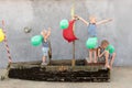 Happy boys play pirates and seafarers. Three brothers have fun together. The old boat is decorated with balloons Royalty Free Stock Photo