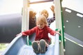 Happy boys playing at the playground at sunny day