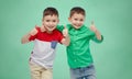 Happy boys showing thumbs up over school board Royalty Free Stock Photo