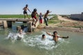 Boys playing in an irrigation channel near Harran in Turkey.