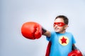 Happy and brave child boy, dressed as superhero, wearing mask and Boxing gloves