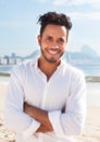 Happy brazilian man standing at Copacabana beach