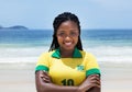 Happy brazilian woman in a soccer jersey at beach Royalty Free Stock Photo