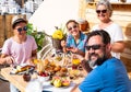 Happy breakfast for caucasian family. Outdoor in the terrace. Healthy eating. Fresh fruit and coffee. Four people Royalty Free Stock Photo