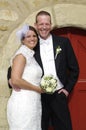 Happy bridal couple smiling at their wedding day