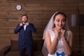 Happy bride against groom talking on the phone Royalty Free Stock Photo