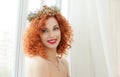 Happy bride. Beautiful red head curly woman with crown fashion model person girl looking at you camera smiling at boyfriend groom Royalty Free Stock Photo