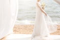 Happy bride with boquet on the beach Royalty Free Stock Photo