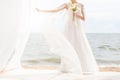 Happy bride with boquet on the beach Royalty Free Stock Photo