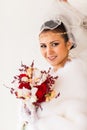 Happy Bride with bouquet and diamond jewelry waiting for groom in winter wedding day Royalty Free Stock Photo