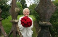 Happy Bride with red roses photographed through the old castle fence