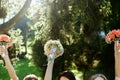 Happy bride and bridesmaids showing their luxury bouquets in han