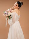 Beautiful bride in design wedding dress with lush bridal bouquet closeup. Wedding studio shot. Royalty Free Stock Photo