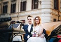 Happy bride and groom in beautiful carriage on wedding walk Royalty Free Stock Photo