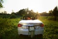 Happy bride and groom in the cabriolet