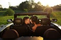 Happy bride and groom in the cabriolet