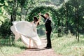 Happy bride and groom dancing under the wedding arch.