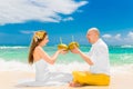 Happy bride and groom drink coconut water and having fun on a tr Royalty Free Stock Photo