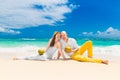 Happy bride and groom drink coconut water and having fun on a tr Royalty Free Stock Photo