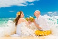 Happy bride and groom drink coconut water and having fun on a tr Royalty Free Stock Photo