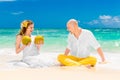 Happy bride and groom drink coconut water and having fun on a tr Royalty Free Stock Photo