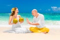 Happy bride and groom drink coconut water and having fun on a tr Royalty Free Stock Photo