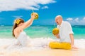 Happy bride and groom drink coconut water and having fun on a tr Royalty Free Stock Photo