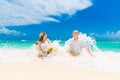 Happy bride and groom drink coconut water and having fun on a tr Royalty Free Stock Photo