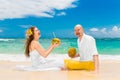 Happy bride and groom drink coconut water and having fun on a tr Royalty Free Stock Photo