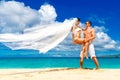 Happy bride and groom having fun on a tropical beach Royalty Free Stock Photo