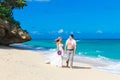 Happy bride and groom having fun on a tropical beach