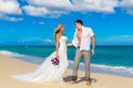 Happy bride and groom having fun on a tropical beach Royalty Free Stock Photo