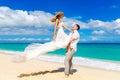 Happy bride and groom having fun on a tropical beach Royalty Free Stock Photo