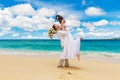 Happy bride and groom having fun on a tropical beach Royalty Free Stock Photo