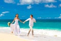 Happy bride and groom having fun on a tropical beach Royalty Free Stock Photo