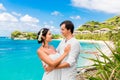 Happy bride and groom having fun on a tropical beach under the p Royalty Free Stock Photo