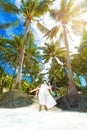 Happy bride and groom having fun on a tropical beach under the p Royalty Free Stock Photo