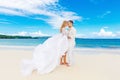 Happy bride and groom having fun on a tropical beach. Wedding an Royalty Free Stock Photo