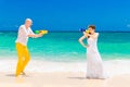 Happy bride and groom having fun in the waves on a tropical beach. Wedding and honeymoon on the tropical island Royalty Free Stock Photo