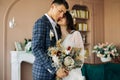 Happy bride and groom holding a bouquet of wedding flowers, Happy young couple, Bride and groom posing and looking at each other Royalty Free Stock Photo