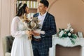 Happy bride and groom holding a bouquet of wedding flowers, Happy young couple, Bride and groom posing and looking at each other Royalty Free Stock Photo