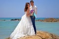 Happy bride and groom hug on the rocks in the Indian Ocean. Wedding and honeymoon in the tropics on the island of Sri Lanka. Royalty Free Stock Photo