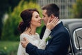 stylish bride and groom sensually posing near retro car with boh Royalty Free Stock Photo