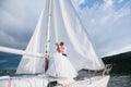 Happy bride and groom hugging on a yacht Royalty Free Stock Photo