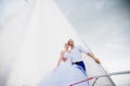 Happy bride and groom hugging on a yacht Royalty Free Stock Photo