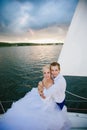 Happy bride and groom hugging on a yacht Royalty Free Stock Photo