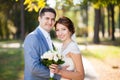 Happy bride, groom looking at camers in green park. Kissing, smiling, laughing. lovers in wedding day. happy young couple in Royalty Free Stock Photo